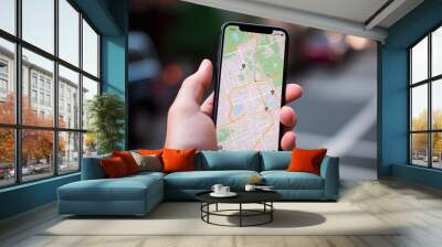 Traveler use map on mobile phone app to search for route location of place with gps on street when travel in city,Technology in lifestyle Wall mural