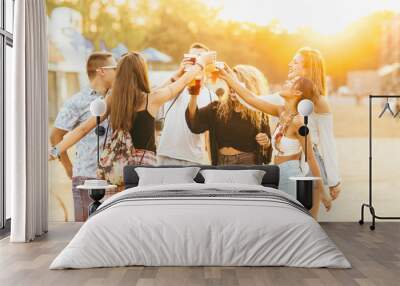 Friends drinking beer and having fun at music festival Wall mural