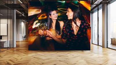 Two girls having fun at the club on New Year's party Wall mural