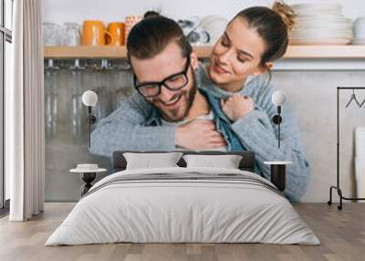 Young couple having fun in kitchen  Wall mural