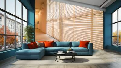 Motorized wood blinds in the interior. Automatic venetian blinds beige color on large windows. Coulisse wooden slats 50mm wide. Wood floor, beige walls. Wall mural