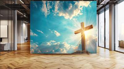 holy sunlight shining on the Christ wooden cross symbol with religious clouds on blue sky background Wall mural