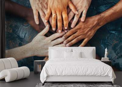 Various diverse people combine holding hands together as a concept of teamwork unity seen from above Wall mural