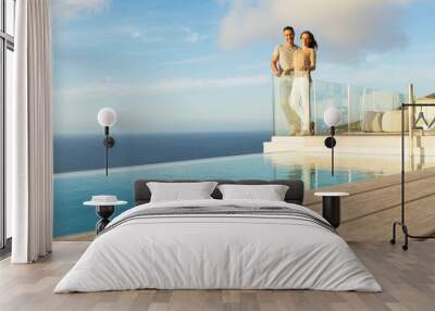 Couple on modern balcony overlooking ocean Wall mural