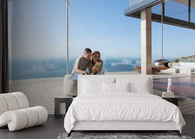 Couple using digital tablet on modern balcony Wall mural