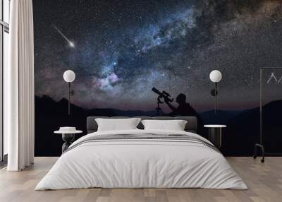 Astronomer looking at the starry skies with a telescope. Wall mural