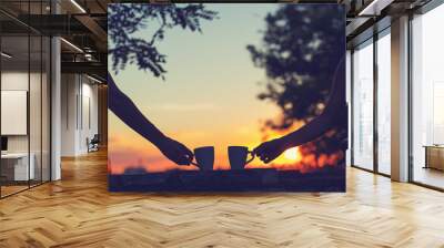 Friends drinking coffee in sunset / sunrise. Shallow depth of field. Wall mural