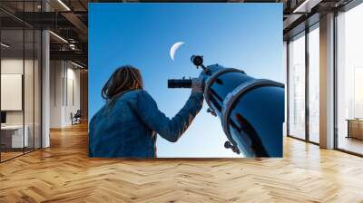 Girl looking at the Moon through a telescope. My astronomy work. Wall mural