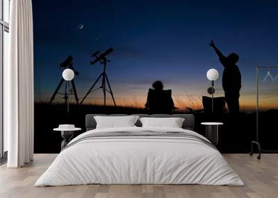 People enjoying watching and stargazing with astronomy telescopes outdoors in nature, observing planets, Moon and other celestial objects. Wall mural