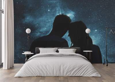 Silhouettes of a young couple under the starry sky.  Wall mural