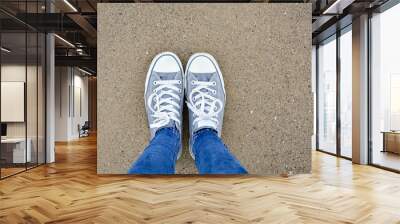 Standing with two shoes on sand from above Wall mural