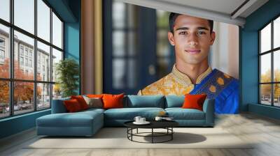 A man in a blue and gold traditional Indian outfit. The photo showcases the elegance and beauty of Indian cultural attire. Wall mural