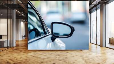 Close up of a car side mirror with blurred city street in background Wall mural