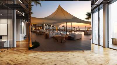 Luxury beach resort with white lounge chairs and palm trees at sunset Wall mural