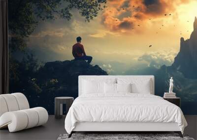 Man meditating on a cliff overlooking a magical landscape with a sunset sky and clouds Wall mural