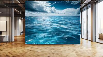 Ocean horizon with blue water, white clouds, and sunbeams. Beautiful seascape for travel and nature photography Wall mural