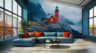 Red lighthouse on a rocky coast with foggy mountains in the background Wall mural