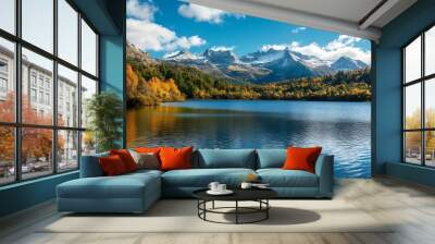 Scenic mountain lake with fall foliage, snow capped peaks, and blue sky with clouds Wall mural