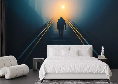 Silhouette of man walking up stairs in fog towards light.  Hope, motivation, and success concept. Wall mural