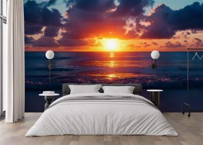 Vibrant sunset over the ocean with clouds and waves Wall mural