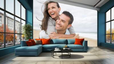 portrait of living young couple at the beach Wall mural