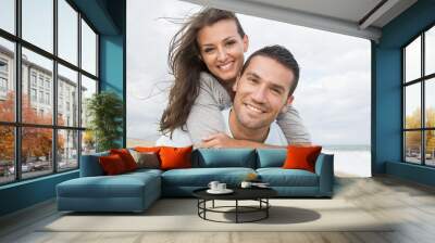 portrait of living young couple at the beach Wall mural