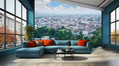 Beautiful cityscape in the valley under cloudy sky in Thailand Wall mural