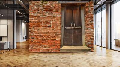 Closed ancient wooden door with red brick wall texture Wall mural