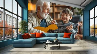 A joyful elderly man shares a cherished moment with his grandson as they play the guitar together in a cozy living room setting.  Wall mural