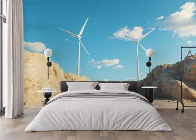 A serene landscape featuring wind turbines surrounded by rocky terrain under a bright blue sky with fluffy clouds, symbolizing renewable energy. Wall mural