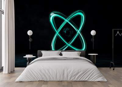 Abstract representation of an atom symbol with glowing turquoise lines on a dark background, illustrating energy and atomic structure. Wall mural