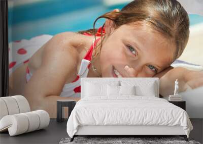 close up of little cheerful girl lying down by the swimming pool  Wall mural