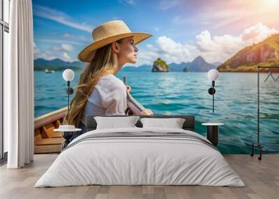 Back view of the young woman tourist in straw hat relaxing on the boat and looking forward into sea. Travelling tour in Asia Wall mural