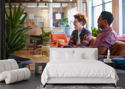 Two people sitting on a couch in a room with plants Wall mural