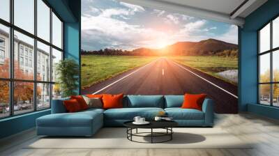 Asphalt road through the green field and clouds on blue sky in summer day. Beautiful grassland road in Thailand.Highland road. Wall mural