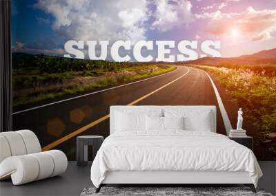 success behind the tree of empty asphalt road at golden sunset and beautiful blue sky. Success concept. Wall mural