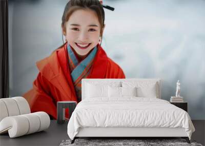 A girl in red against a snow backdrop, grinning in ancient Chinese garments. Wall mural