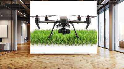 A modern drone placed on lush green grass, showcasing advanced technology for aerial photography and surveillance. Wall mural