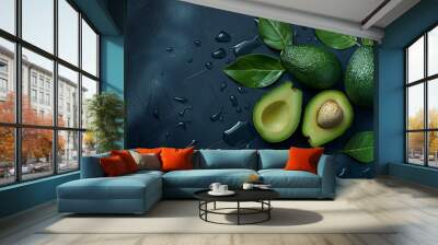 Whole and a half of fresh green avocado isolated on a dark background Wall mural