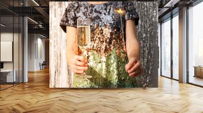 A glass of champagne in the hands of a woman Wall mural