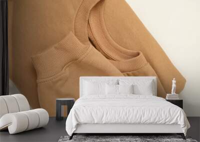 Blank beige folded sweatshirt on white background Wall mural