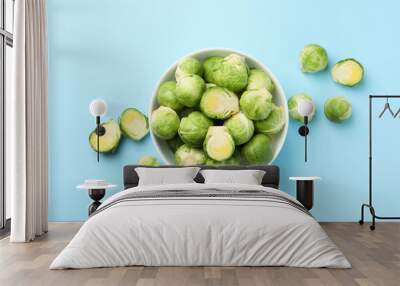 Bowl with brussels sprout on blue background, top view Wall mural