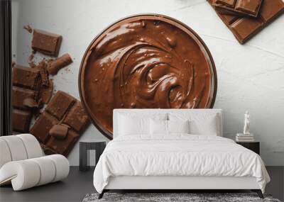 Bowl with chocolate and chocolate pieces on white background Wall mural