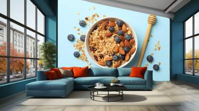 Bowl with granola and dipper on blue background Wall mural