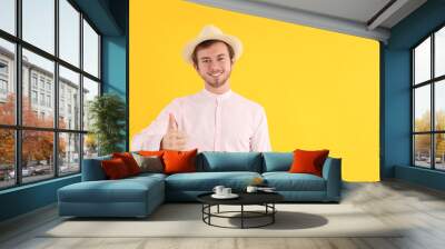 Concept of people, young man on yellow background Wall mural