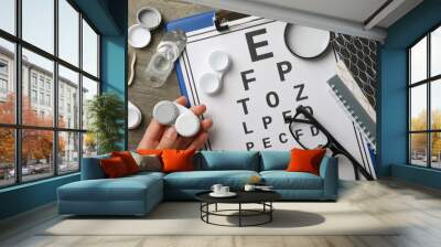 Contact lenses with accessories and a sight test plate Wall mural