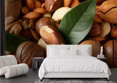 Different tasty nuts on whole background, close up Wall mural