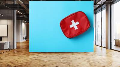 First aid medical kit on blue background Wall mural