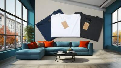 Folded blank t-shirts with tags on gray background, space for text Wall mural