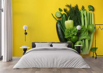 Fresh green vegetables on yellow background, space for text Wall mural